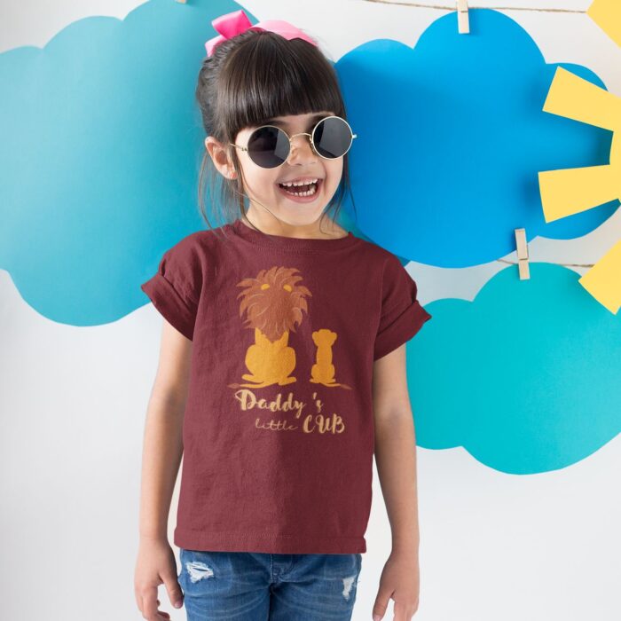 smiling-girl-wearing-a-round-neck-tshirt-template-near-cardboard-sun-and-clouds-a19480.png