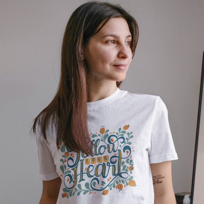 basic-t-shirt-mockup-of-a-calm-woman-with-tattoos-at-home-m1605-r-el2.png