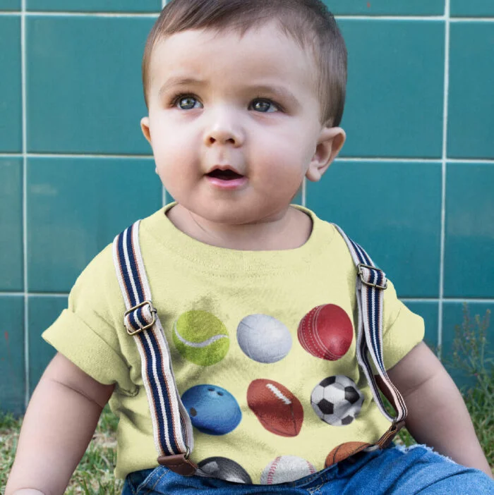 little-baby-boy-wearing-a-round-neck-tee-mockup-while-sitting-down-in-the-grass-16083.png
